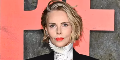 Charlize Theron scales Times Square to promote Apex